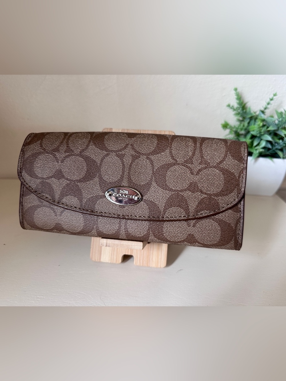 Coach Brown Signature Continental Wallet with red accents and insert pouch.